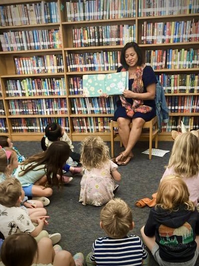 Librarian reading picture book aloud to Parkies